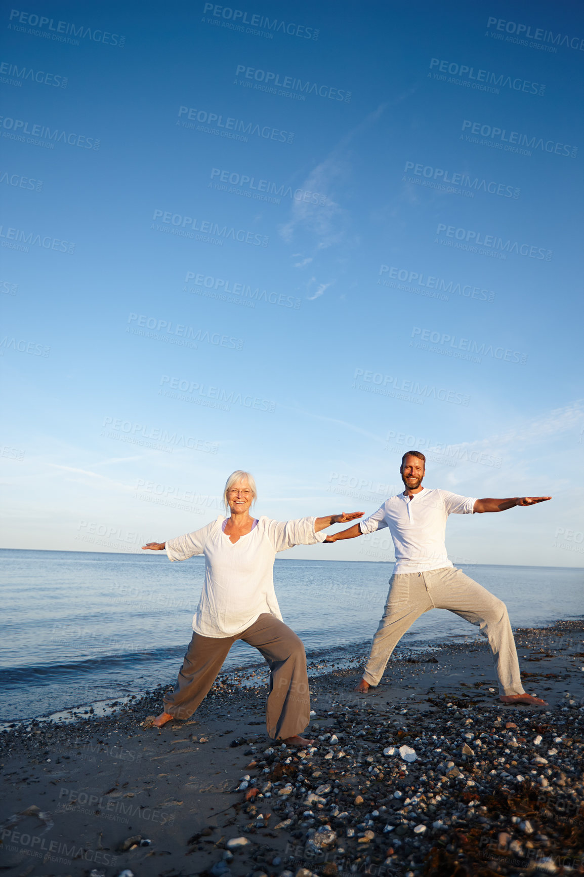 Buy stock photo Portrait, couple and stretching for yoga by ocean with holistic care, spiritual wellness and mindfulness. Mature people, warm up and pilates peace, mindset healing and performance for fitness outdoor