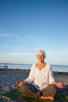 Buy stock photo Portrait, woman and meditation for yoga by ocean with holistic care, spiritual wellness and mindfulness. Mature person, namaste and pilates peace, mindset healing and performance with fitness outdoor