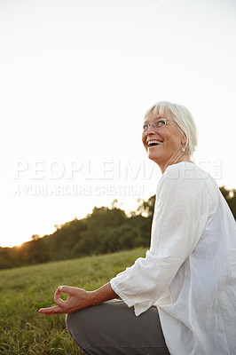 Buy stock photo Shot of an attractive mature woman doing yoga in nature