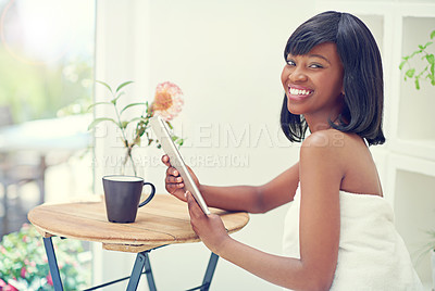 Buy stock photo Happy, black woman and home with tablet on towel to browse internet for beauty or skincare tips or routine. Female person, portrait and relax in morning with social media, networking or communication