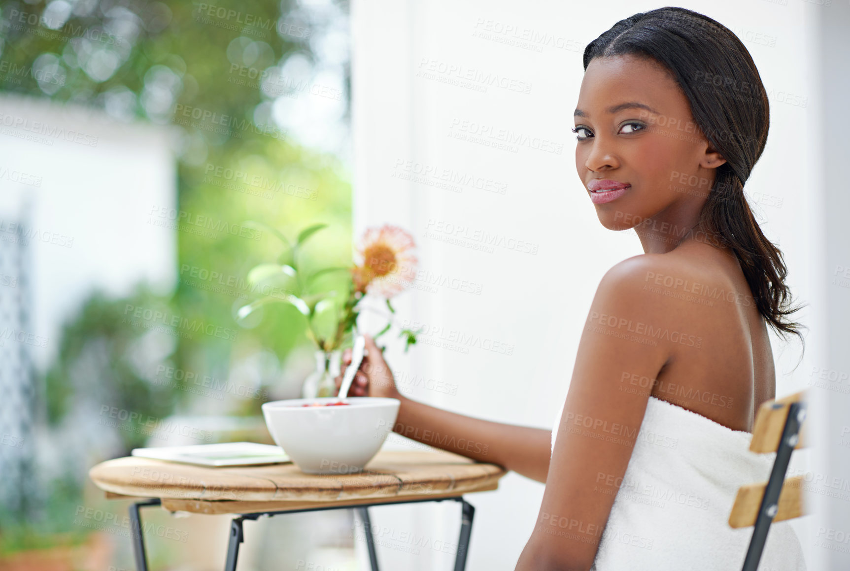 Buy stock photo Shot of a beautiful young woman eating strawberries