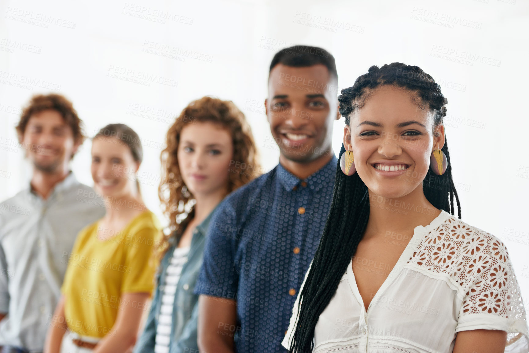 Buy stock photo Cropped portrait of a group of young coworkers standing against a white background