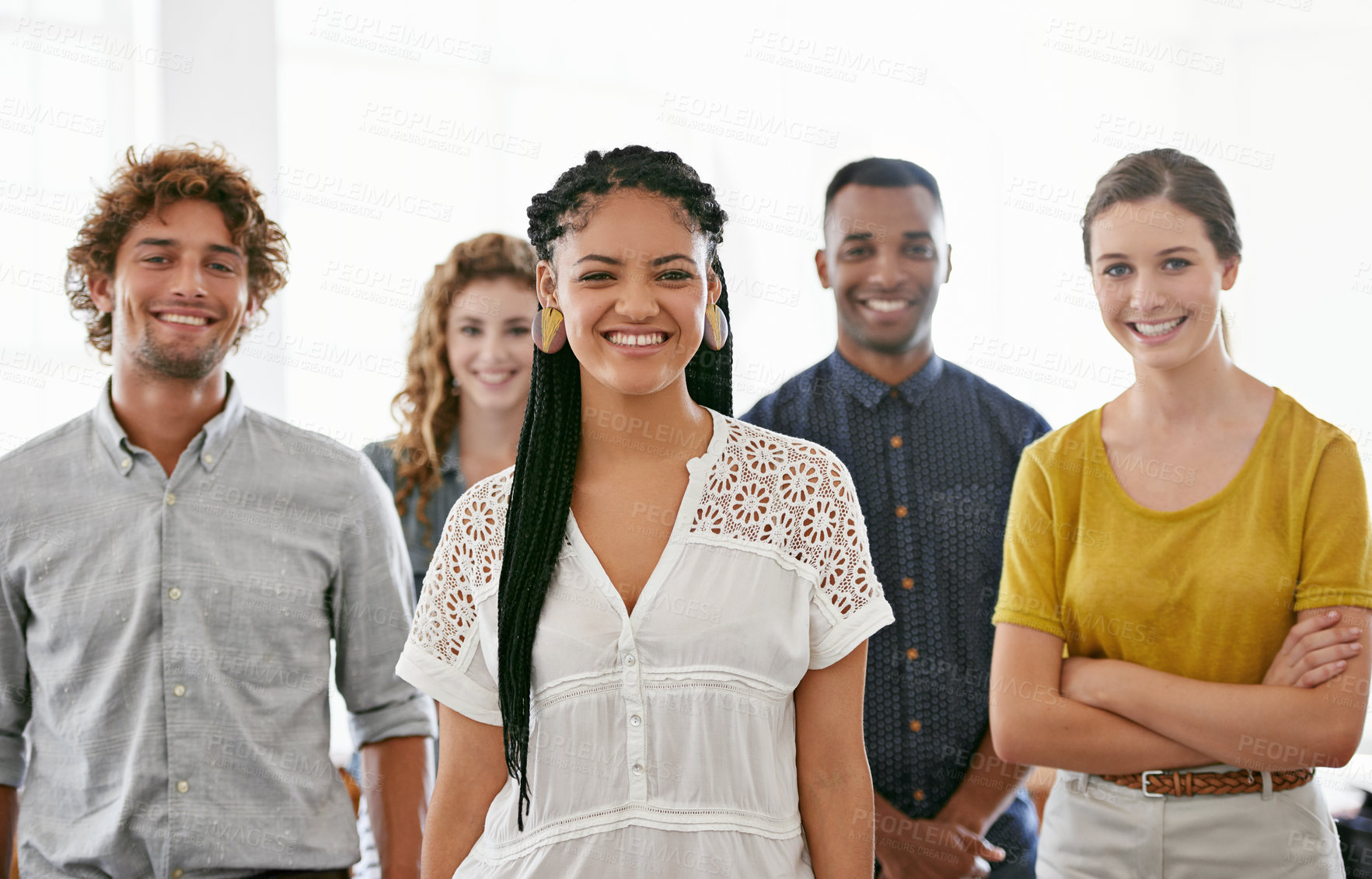 Buy stock photo Cropped portrait of a diverse group of young colleagues standing in a brightly lit office