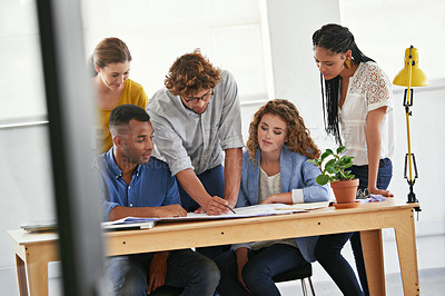 Buy stock photo Diversity, business people and writing with documents for planning, teamwork or collaboration at the office. Group of employees in meeting working on paperwork together for project plan at workplace