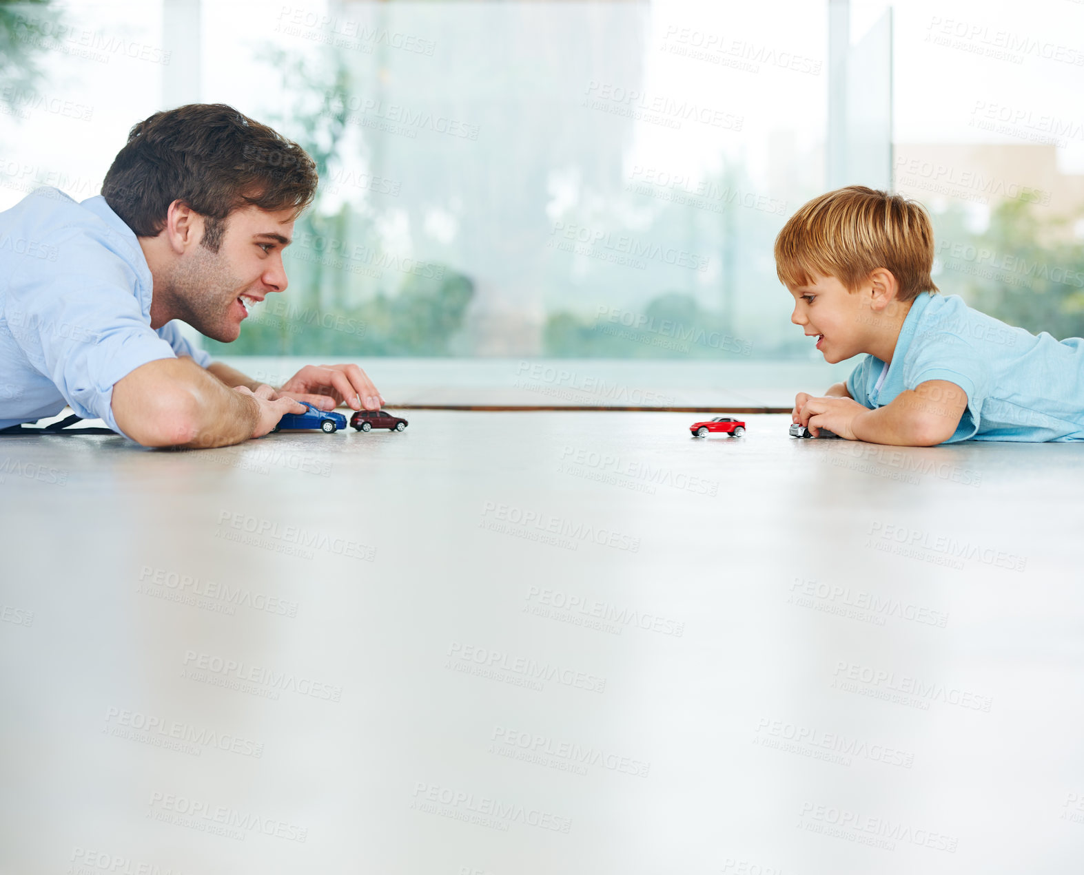 Buy stock photo Playing, happy and a father and child with cars for bonding, quality time and happiness. Smile, family and a dad with a boy kid and toys for a race or competition on the floor of a house together