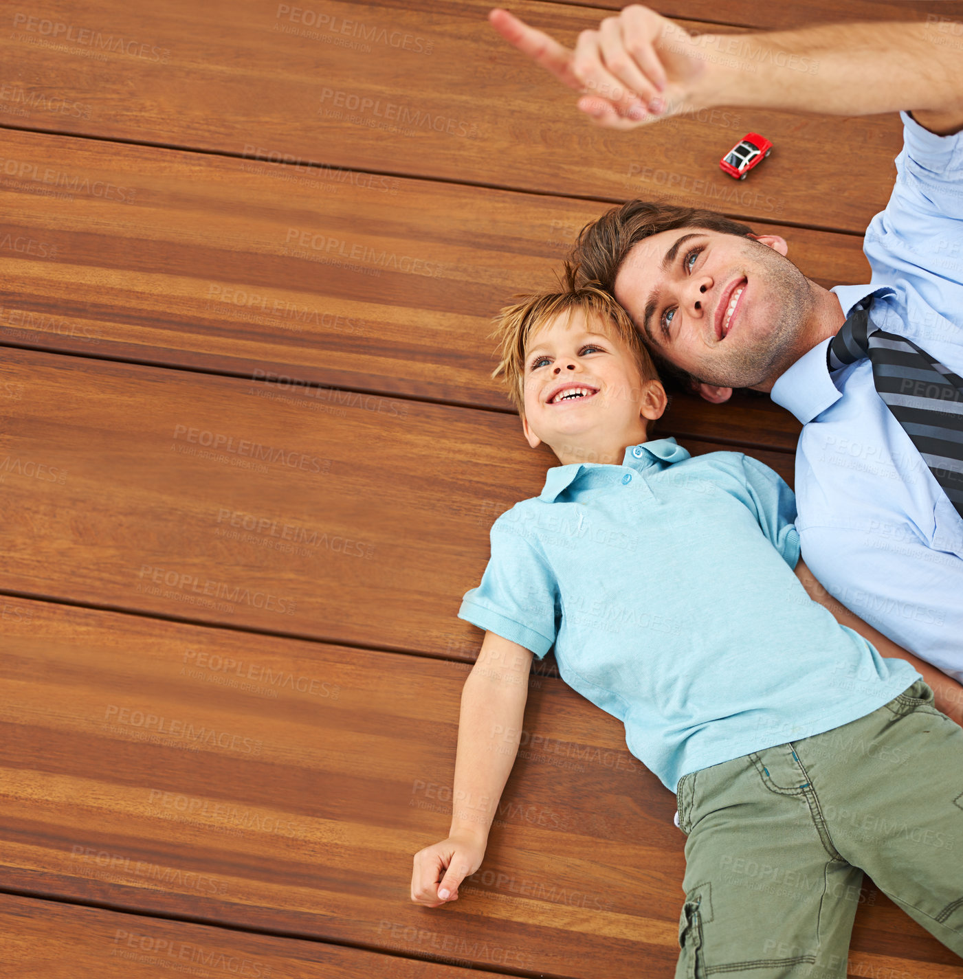 Buy stock photo Dad, child and toy playing on floor by pointing at roof in house for fun, learning and connection. Single father, male kid and little car in home with smile for happy, child development and bonding