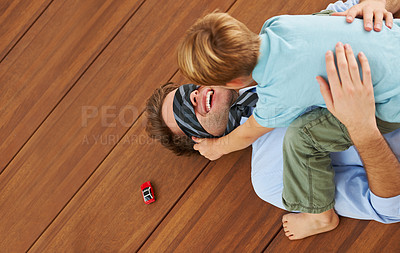 Buy stock photo Man, blindfold and playing games with child on living room, floor and happy family with love. Businessman, boy and quality time together with trust in house, toy and care to relax by support father