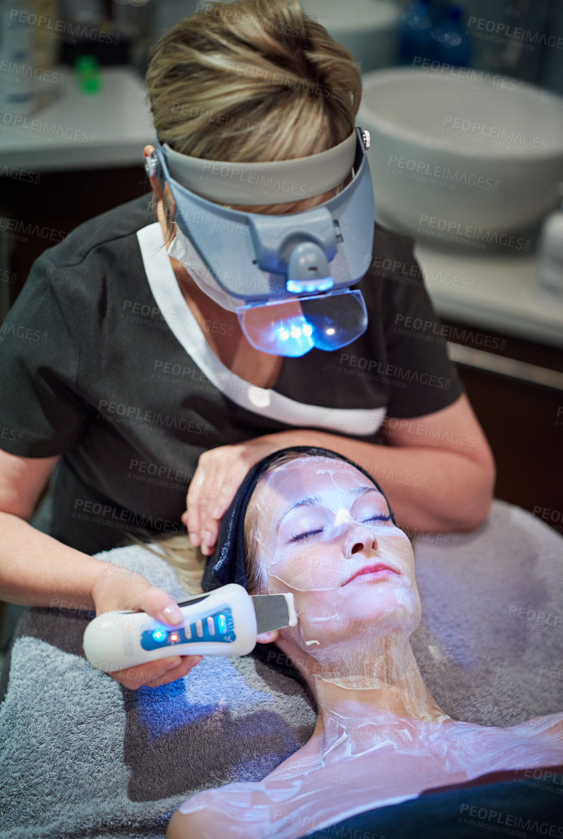 Buy stock photo Shot of a woman getting a non-invasive face lift at a beauty clinic