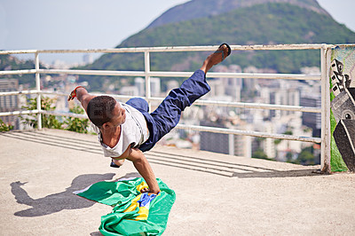 Buy stock photo Shot of a young male breakdancer in an urban setting