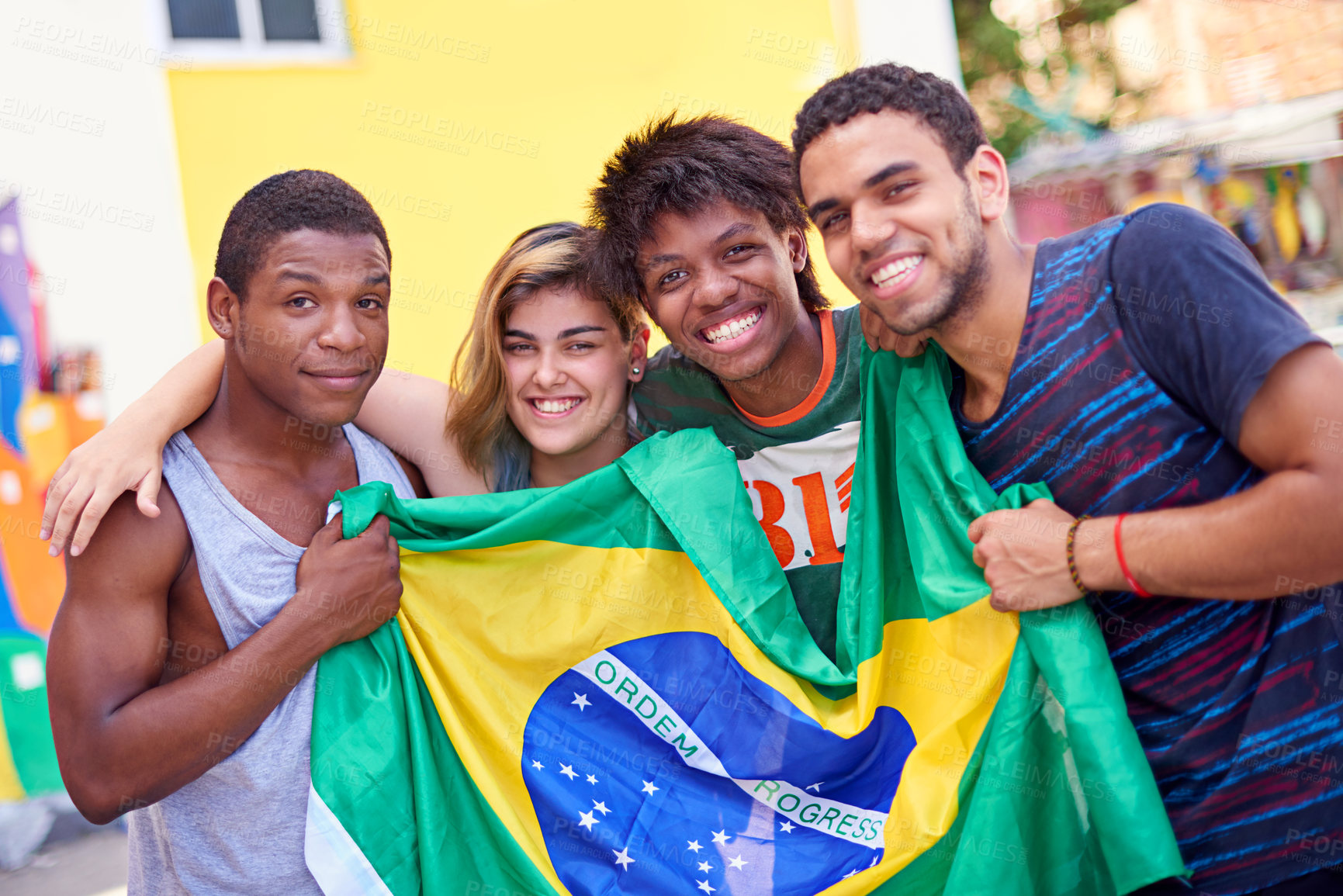Buy stock photo Portrait of a group of teenagers holding up the Brazilian flag