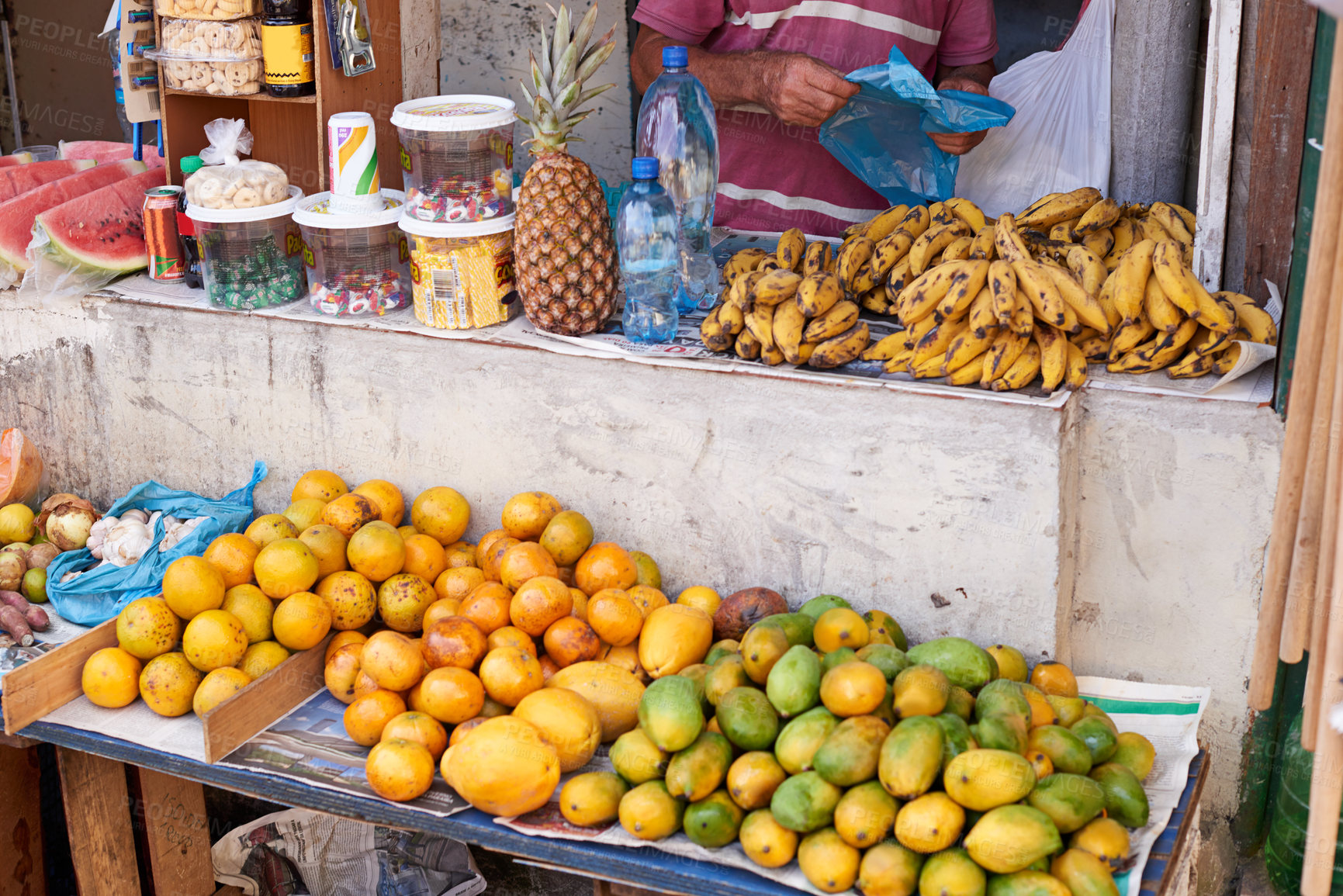 Buy stock photo Cropped shot of a street vendor selling food at his market stall