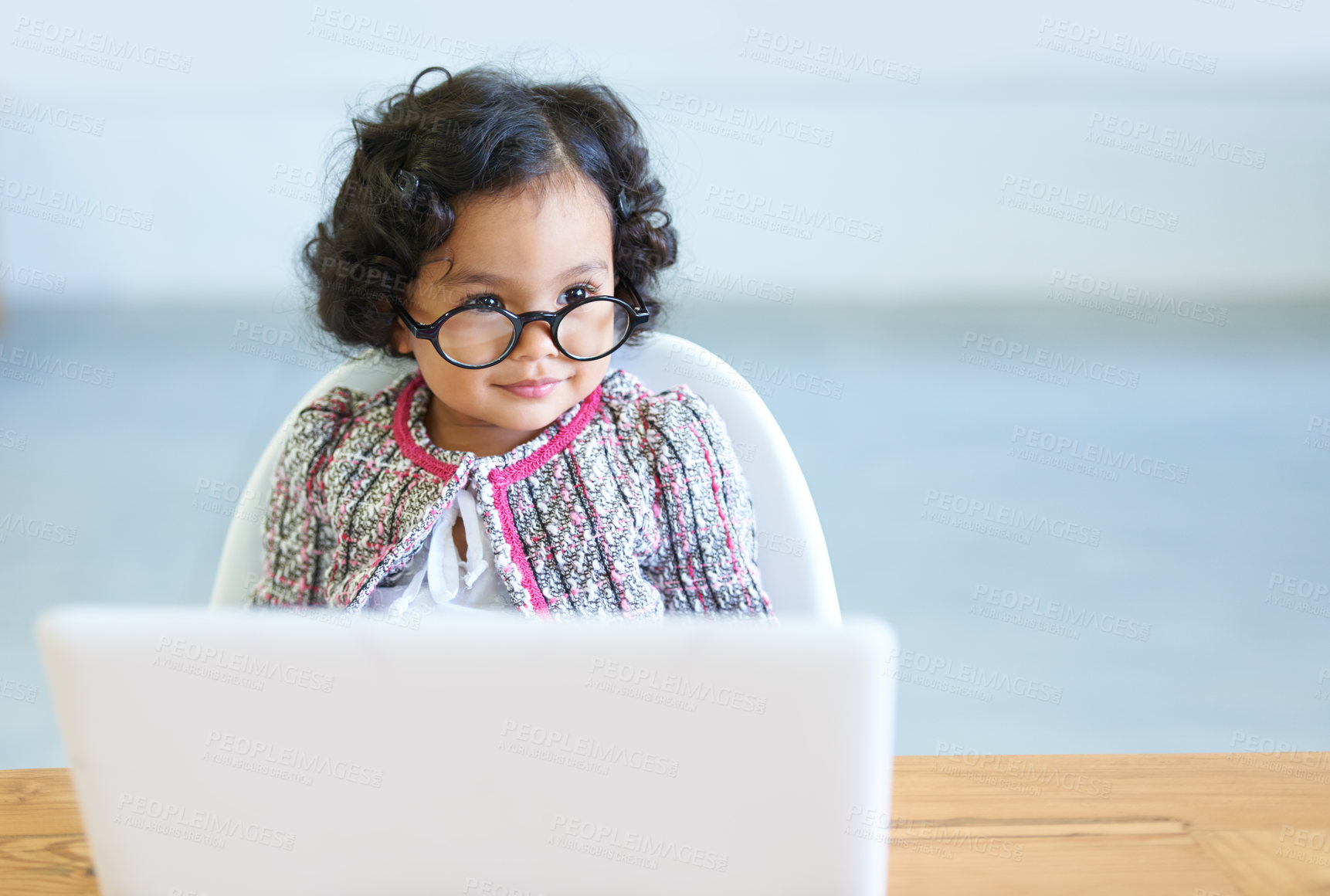 Buy stock photo Young child, laptop and glasses at table for online learning education, development or growth. Female toddler person, internet or connection homework studying, virtual school or youth comedy dress up
