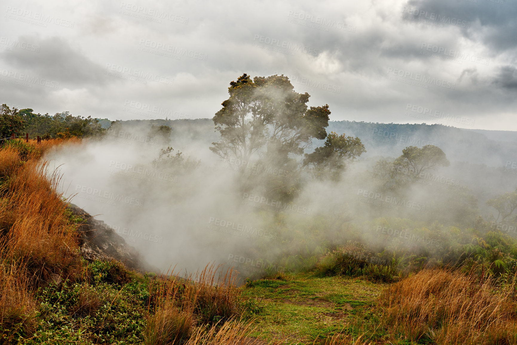 Buy stock photo Landscape of misty mountain on Big Island of Hawaii. Scenic view of Mauna Kea, dormant volcano in a remote area with copy space. Vast foggy expanse of nature and blue sky near summit of volcanic land