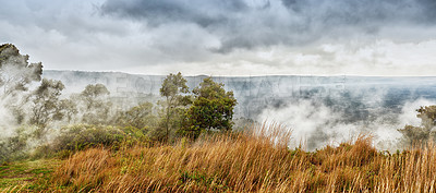 Buy stock photo Landscape of misty mountain on Big Island of Hawaii. Scenic view of Mauna Kea, dormant volcano in a remote area with copyspace. Vast foggy expanse of nature and blue sky near summit of volcanic land