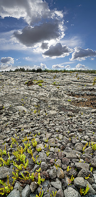 Buy stock photo Landscape of cooled lava flow with copy space, Big Island, Hawaii. Scenic view of Mauna Kea, a dormant volcano in a secluded open location. Blue cloudy sky near stone ground summit of a volcanic land