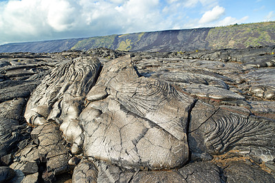 Buy stock photo Closeup of Muana Loa, the world's biggest active volcano, Hawaii. Zoom in a details and patterns of flowing lava on against a mountain landscape. Shield volcanoes are the largest mountains on Earth