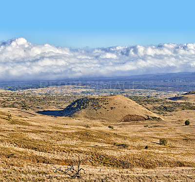 Buy stock photo Landscape of barren and dry land on the Big Island of Hawaii. Scenic view of Mauna Kea, dormant volcano in remote area with copyspace. Vast expanse of nature and blue sky near summit of volcanic land