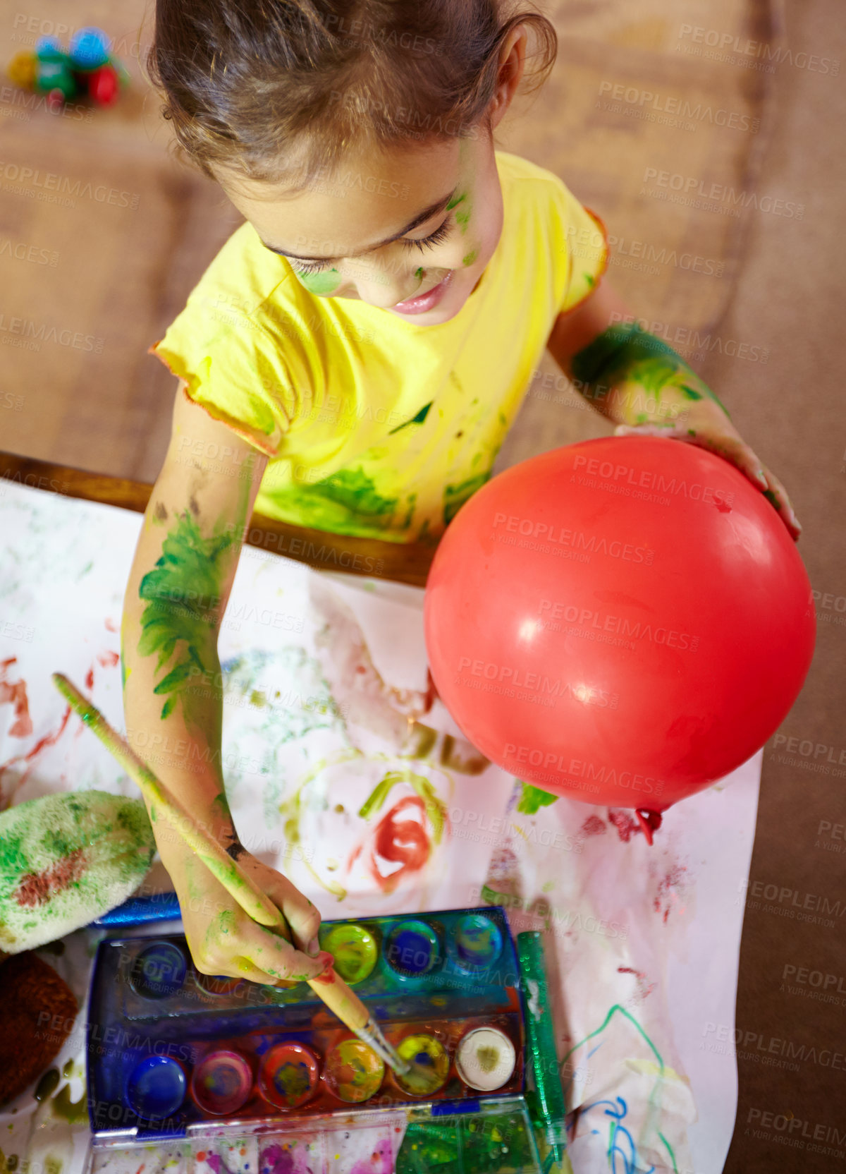 Buy stock photo Painting, creative and girl kid with brush for homework, assignment or project with school at home. Color, fun and child create art on paper with balloon for hobby, development or activity from above