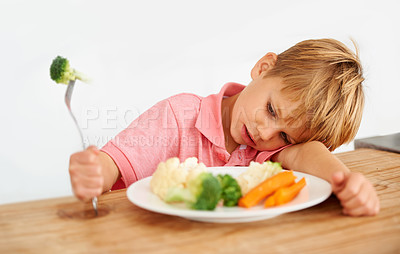 Buy stock photo Sad, diet and a child with vegetables for dinner, unhappy meal and problem with food. Frustrated, hungry and dislike of boy kid eating broccoli, carrots and disappointed with healthy lunch at home