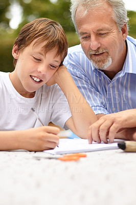 Buy stock photo Family, son and father with homework outdoor for helping, learning and development with happiness at home. Man, child and notebook, writing or reading with stationary in backyard of house with smile