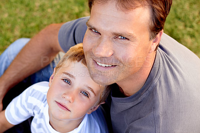 Buy stock photo Smile, portrait and dad with son on grass, cute bonding together with care and love in backyard from above. Fun, father and child in garden with happy relationship, trust and support with man and boy
