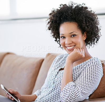 Buy stock photo Portrait of an attractive woman sitting on the sofa with her smartphone