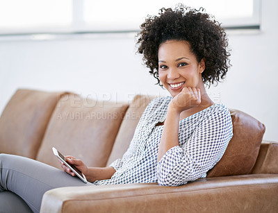 Buy stock photo Portrait of an attractive woman sitting on the sofa with her smartphone