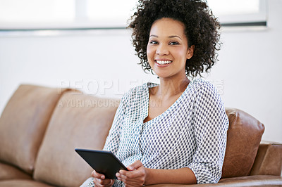 Buy stock photo Portrait of an attractive woman relaxing at home with a digital tablet