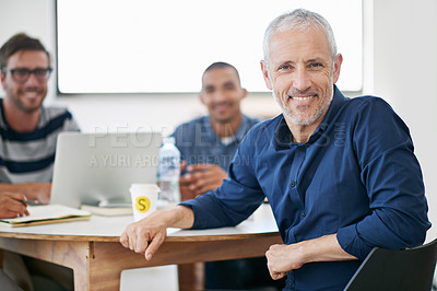 Buy stock photo Portrait of a diverse group of colleagues working around a table
