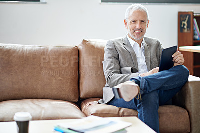 Buy stock photo Portrait of a mature man relaxing with his digital tablet in his living room