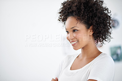 Buy stock photo Shot of an attractive young woman standing in the office. The commercial designs displayed  represent a simulation of a real product and have been changed or altered enough by our team of retouching and design specialists so that they don't have copyright infringements