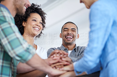 Buy stock photo Shot of a smiling group of coworkers standing in a huddle in an office