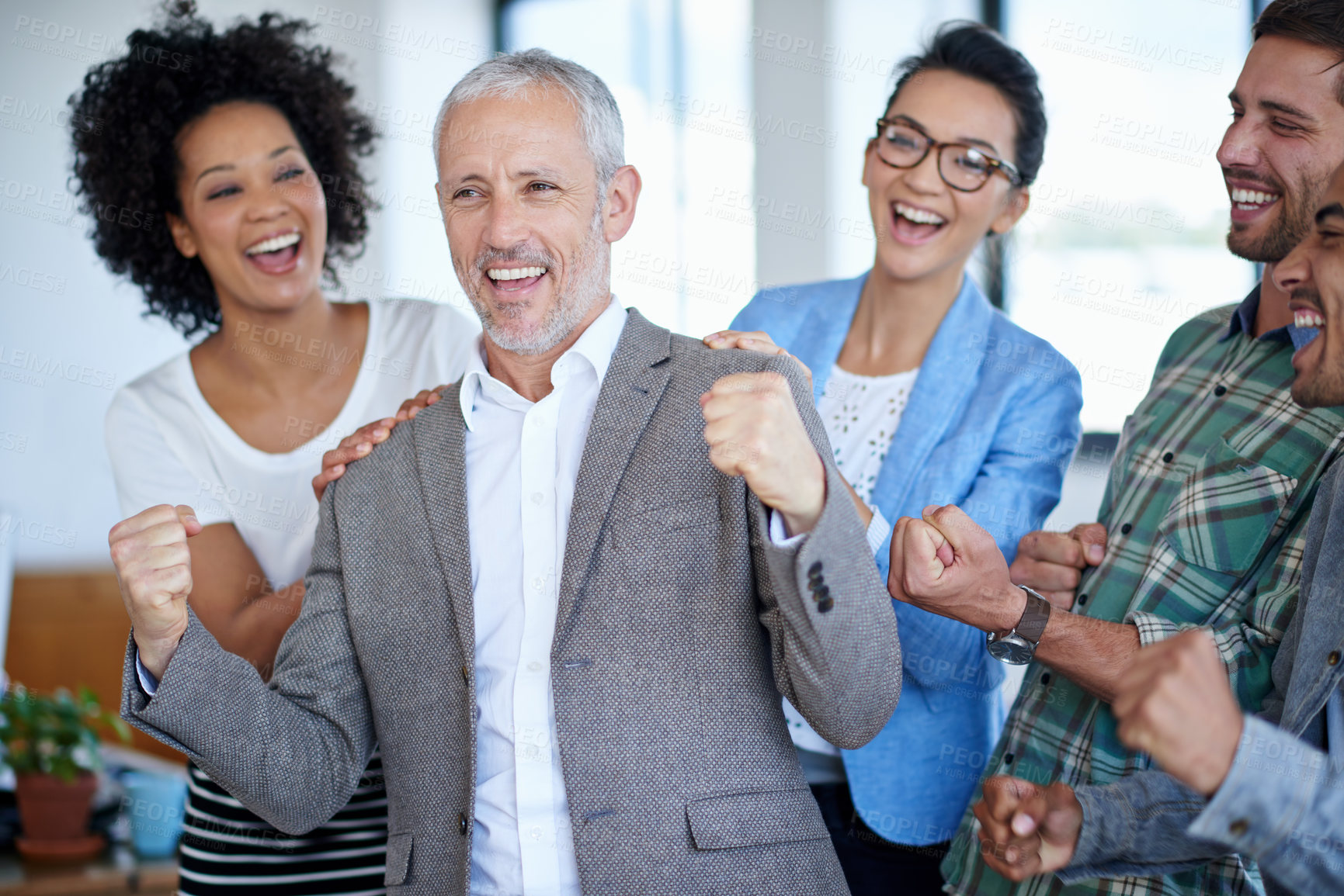 Buy stock photo Shot of a excited coworkers cheering in an office