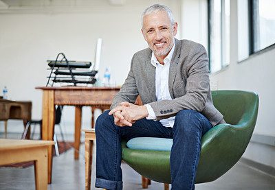 Buy stock photo Portrait of a mature businessman sitting in a chair in an office