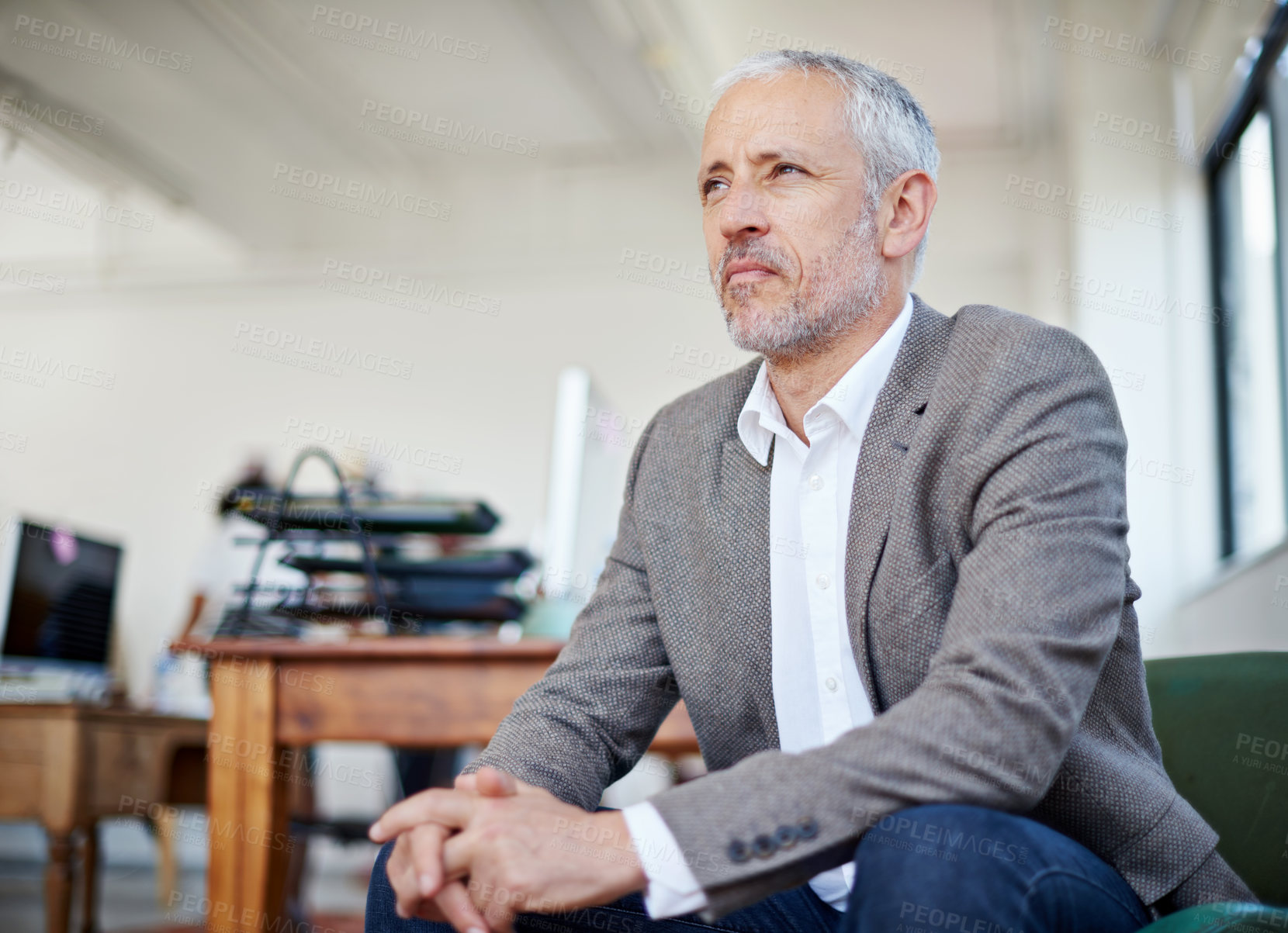 Buy stock photo Shot of a mature businessman sitting in an office
