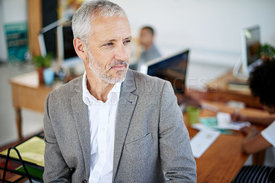 Buy stock photo Shot of a mature businessman standing in an office