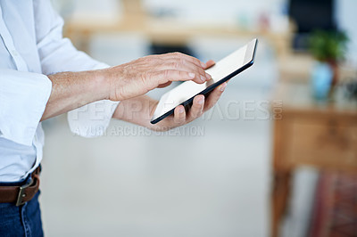 Buy stock photo Cropped shot of an office worker using a digital tablet