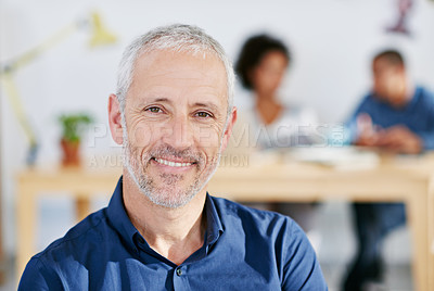 Buy stock photo Portrait of a handsome businessman sitting in his office. The commercial designs displayed  represent a simulation of a real product and have been changed or altered enough by our team of retouching and design specialists so that they don't have copyright infringements