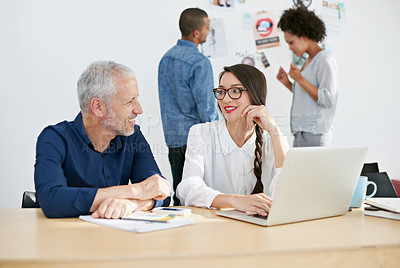 Buy stock photo Cropped shot of four businesspeople working in their office. The commercial designs displayed represent a simulation of a real product and have been changed or altered enough by our team of retouching and design specialists so that they don't have copyright infringements
