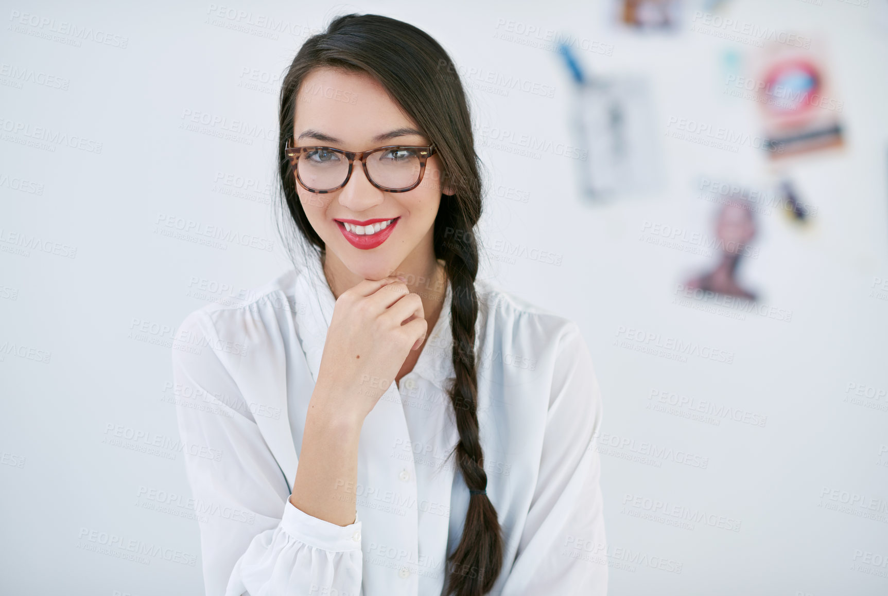 Buy stock photo Portrait of a beautiful young woman working in a modern office. The commercial designs displayed represent a simulation of a real product and have been changed or altered enough by our team of retouching and design specialists so that they don't have copyright infringements