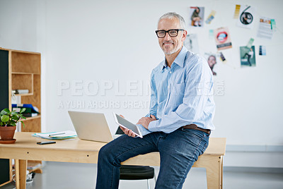 Buy stock photo Portrait of a handsome businessman working on a digital tablet. The commercial designs displayed represent a simulation of a real product and have been changed or altered enough by our team of retouching and design specialists so that they don't have copyright infringements