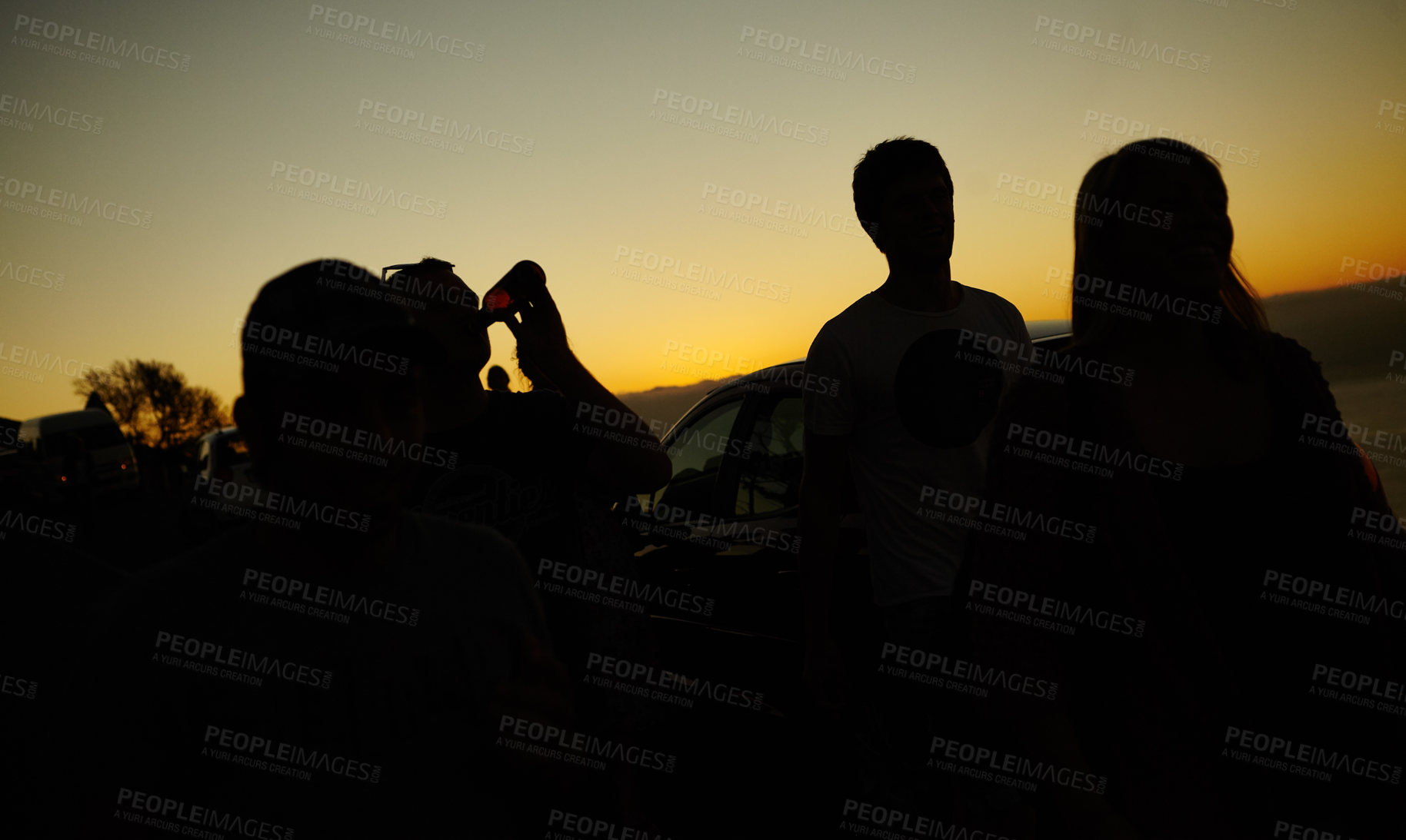 Buy stock photo Silhouette of a group of friends against a yellow sunset