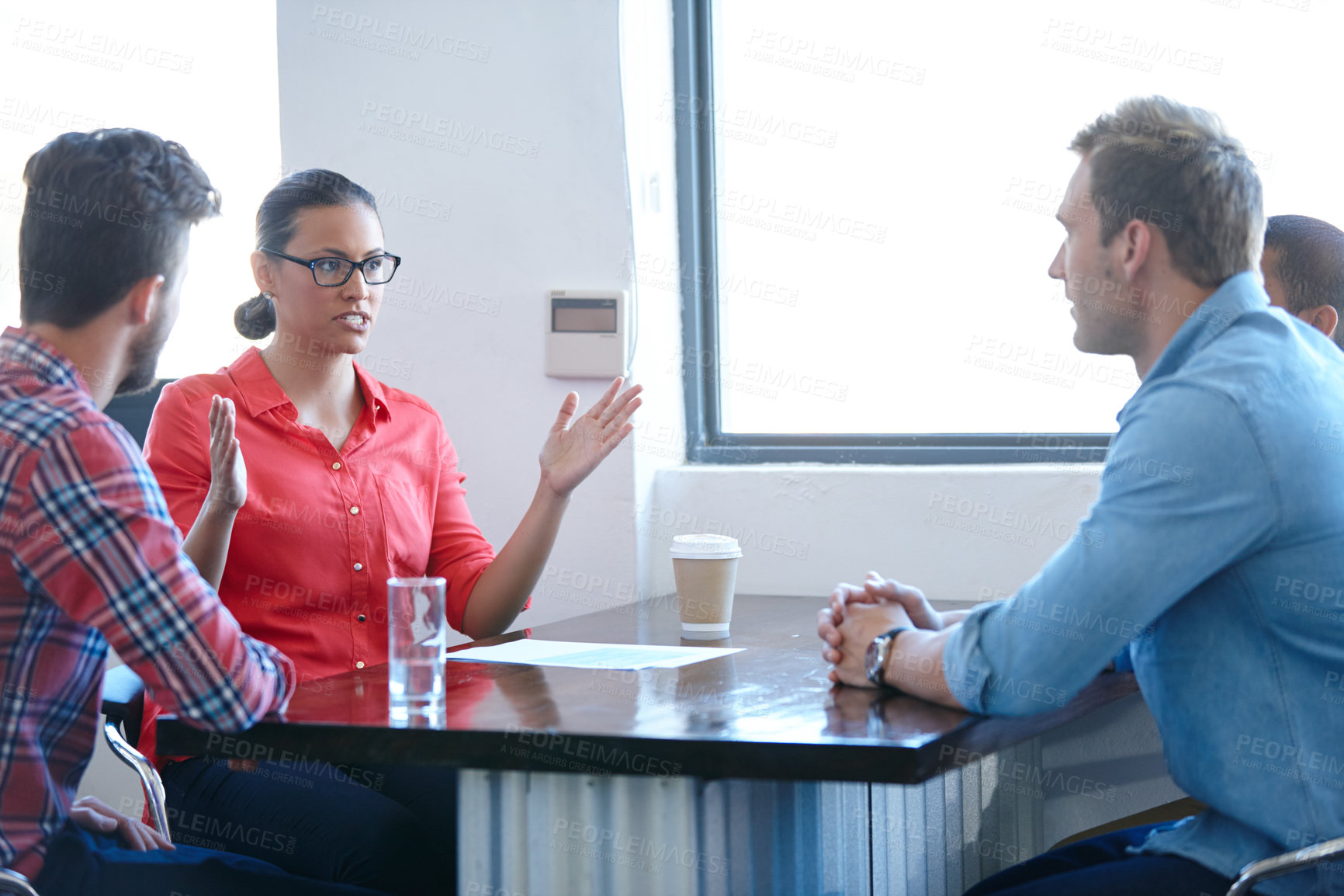 Buy stock photo Shot of of a female designer sharing her ideas with her colleagues in a meeting