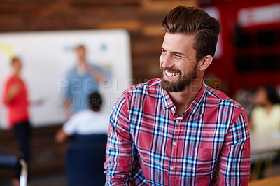 Buy stock photo Shot of a cheerful young male designer in a casual work environment