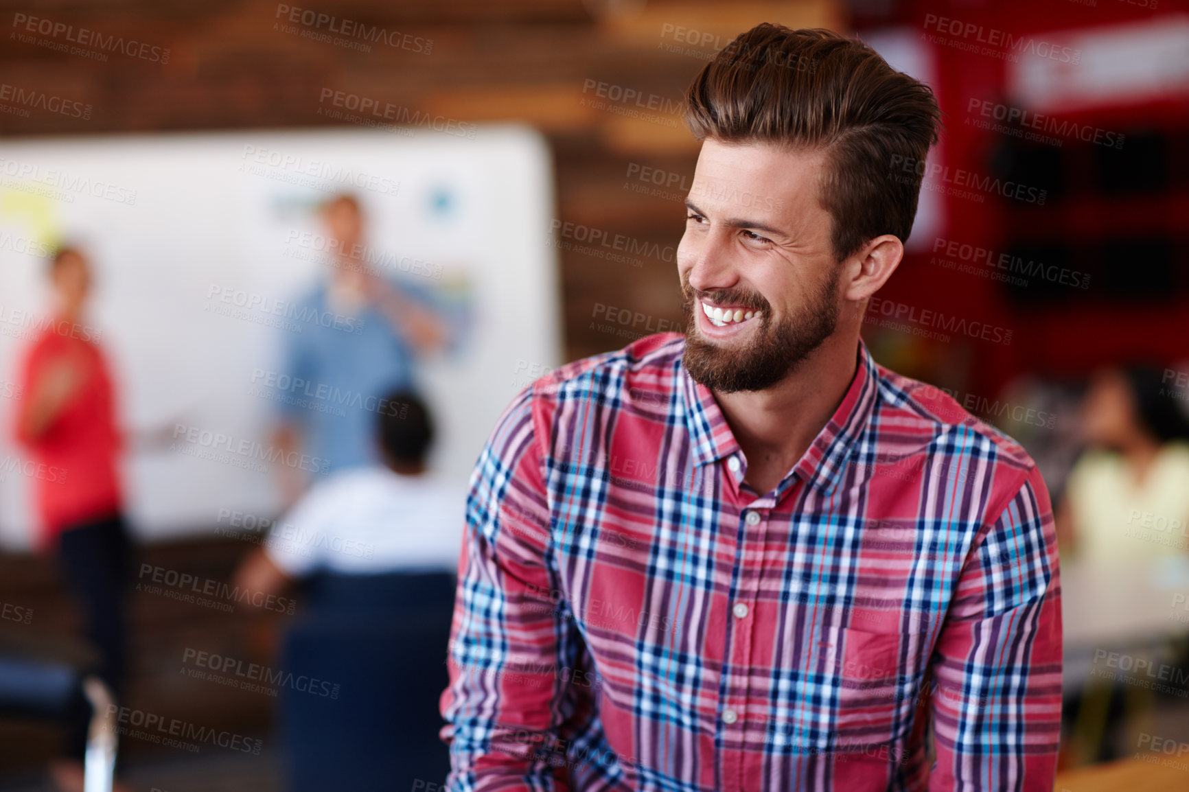 Buy stock photo Shot of a cheerful young male designer in a casual work environment