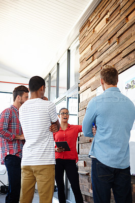 Buy stock photo Shot of a group of designers discussing ideas in a meeting