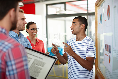 Buy stock photo Shot of a group of designers discussing ideas in a meeting