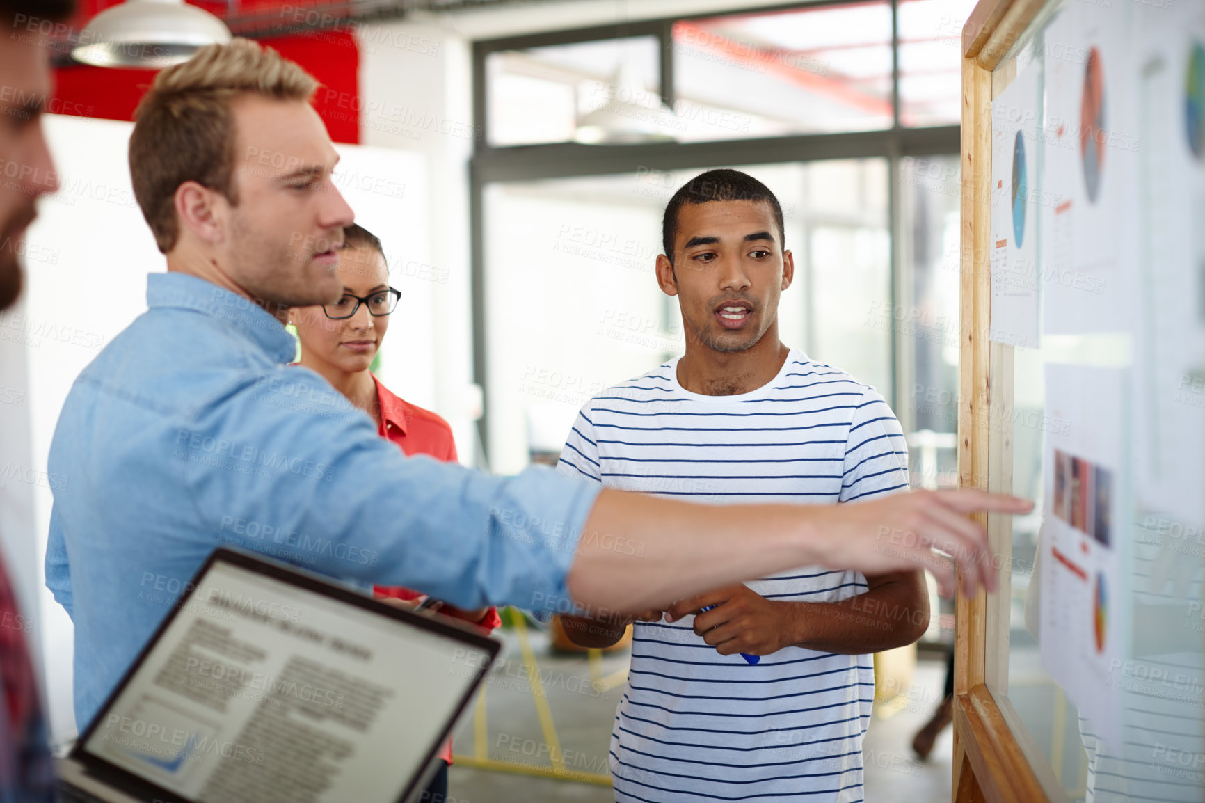 Buy stock photo Shot of a group of designers discussing ideas in a meeting