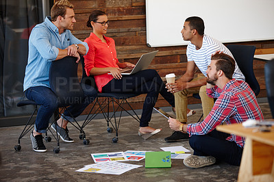 Buy stock photo Shot of a group of young designers having an informal meeting
