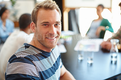 Buy stock photo Portrait of a male designer in a meeting with his colleagues in the background